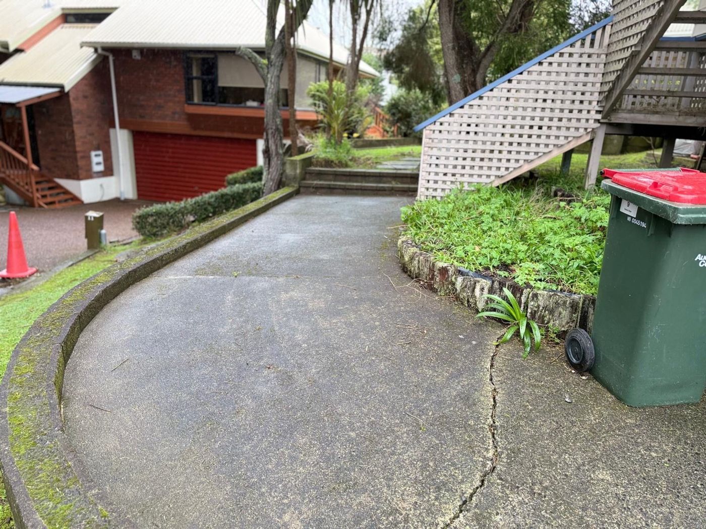 Mossy Auckland driveway ready for pressure cleaning by Signature Greens